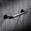 A black grab bar mounted on a gray tiled wall. Produktbild-Vorschau