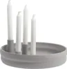 A light gray round candle holder with four white candles. Produktbild-Vorschau