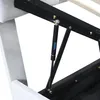 A close-up view of the hydraulic mechanism of a bed frame, showing a gas spring. Produktbild-Vorschau