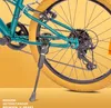 Close-up of the rear wheel, chain, and kickstand of a teal bicycle. Produktbild-Vorschau