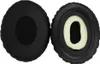 Two black ear pads for headphones are shown against a white background. One ear pad is shown from the outside, and the other is shown from the inside, revealing the cream-colored foam padding. Podgląd zdjęcia produktu