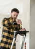 A man is working on a ladder, using a screwdriver. Podgląd zdjęcia produktu
