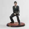 A figurine of Tony Montana from Scarface, holding a gun, on a red and gold base. Podgląd zdjęcia produktu