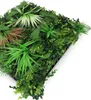A close-up, angled view of a modular artificial plant wall panel, showcasing a variety of green and brown artificial plants. Produktbild-Vorschau