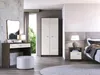 A bedroom scene featuring a vanity, wardrobe, and bedside table. Podgląd zdjęcia produktu