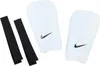 A pair of white Nike shin guards with black Nike swoosh logos and two black straps are laid out on a white background. Anteprima dell’immagine prodotto