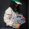 A person holding a tablet with Squid Game stickers. Náhled obrázku produktu