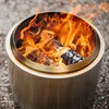 A close-up shot of a Solo Stove Bonfire with flames burning inside, set on a gravel surface. Produktbild-Vorschau