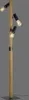 A floor lamp with a wooden pole and three black adjustable spotlights. Produktbild-Vorschau