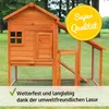 A wooden chicken coop with an attached run, set in a grassy outdoor area with trees in the background. A yellow circular overlay with text is present in the upper right corner, and a green checkmark with text is in the lower left corner. Produktbild-Vorschau