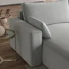 A close-up view of a gray sofa armrest and cushion, with a small side table and decorative vase in the background. Produktbild-Vorschau