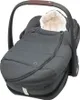 A dark gray baby car seat with a fluffy white lining and a dark gray cover. Produktbild-Vorschau