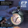 A hand is shown activating the night light on a retro alarm clock, with a couple sleeping in the background. Produktbild-Vorschau