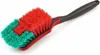 A cleaning brush with red and green bristles and a black and red handle, isolated on a white background. Produktbild-Vorschau