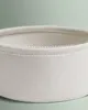 Close-up view of a textured fabric basket with white stitching. Produktbild-Vorschau