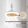 A modern ceiling fan with integrated LED lighting, shown hanging from a white ceiling against a white brick wall. An inset image highlights a feature of the fan, and light rays emanate from it, indicating air movement. Náhled obrázku produktu