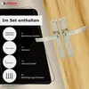 A set of door handles and their included accessories are displayed against a black background and a wooden surface. Produktbild-Vorschau
