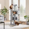 Three cats interacting with a multi-level cat tree in a well-lit living room. Produktbild-Vorschau