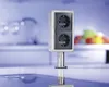 A stainless steel power outlet with two sockets, mounted on a countertop in a modern kitchen. Produktbild-Vorschau