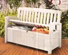 A white storage bench in an outdoor setting with plants in the background. Náhľad obrázku produktu