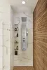 A modern shower stall with a stainless steel shower panel and wood-paneled wall. Podgląd zdjęcia produktu
