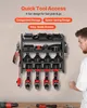 A man is looking at a wall-mounted tool organizer filled with drills and batteries. Produktbild-Vorschau