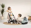 Two children playing with a doll stroller and bassinet. Produktbild-Vorschau
