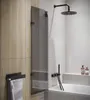 A modern bathroom with a bathtub, shower, and towel rack. Anteprima dell’immagine prodotto