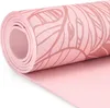 A close-up, rolled yoga mat with a leaf pattern. Podgląd zdjęcia produktu