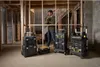 A man is using a drill in a room under construction, surrounded by Stanley PRO-STACK toolboxes. Voir les images du produit