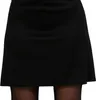 A close-up shot of a black skirt worn by a person. Náhled obrázku produktu