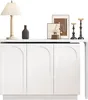 A white sideboard with arched doors, decorated with a lamp, a vase, framed pictures, and candle holders. Náhľad obrázku produktu