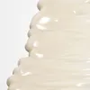 A close-up, abstract view of a creamy substance, likely a cosmetic product, against a white background. Produktbild-Vorschau