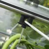 A close-up view of a black plastic plant holder attached to a metal rail, with a white rope passing through it and supporting green plants below. Náhled obrázku produktu