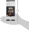 A hand is holding a chocolate bar package. A ruler is shown next to the package indicating its dimensions. Produktbild-Vorschau