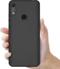 A hand holding a black smartphone case. Náhľad obrázku produktu