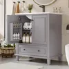 A gray bathroom vanity with its door open, showing storage inside, placed in a bathroom setting. Podgląd zdjęcia produktu