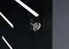 A close-up of a lock on a black surface with white stripes. Podgląd zdjęcia produktu
