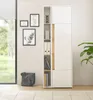 A modern white and wood tone storage cabinet with open shelving, displayed in a well-lit room with artwork on the wall and a window view. Produktbild-Vorschau