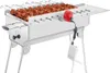 A stainless steel charcoal grill with skewers of meat, a red motor, and a white power bank. Produktbild-Vorschau