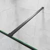 A close-up view of a black metal frame and green glass edge of a shower wall, mounted against a tiled wall. Produktbild-Vorschau