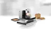 A silver and black electric slicer is shown with a piece of meat and two slices of bread. Anteprima dell’immagine prodotto
