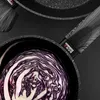 A close-up view of a red cabbage in a black frying pan with a patterned handle. Produktbild-Vorschau