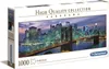 The image shows the front and side of a puzzle box. The front of the box displays a panoramic image of the New York City skyline at night, featuring the Brooklyn Bridge. The side of the box has text and branding. Náhled obrázku produktu