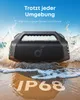 A portable speaker is shown on a beach with waves crashing around it. Voir les images du produit