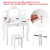 A white wooden children's vanity table and stool with a tri-fold mirror, shown with a close-up inset demonstrating how to attach it to the wall for stability. Podgląd zdjęcia produktu