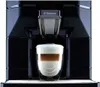 A Saeco coffee machine is dispensing a latte into a glass. Produktbild-Vorschau