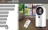 A white bladeless fan heater with a remote control is shown in a living room setting with a window view. Produktbild-Vorschau