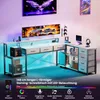 A gaming desk setup with a monitor, controllers, and LED lighting. Produktbild-Vorschau