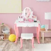 A child's vanity set with a stool in a pink room. Produktbild-Vorschau